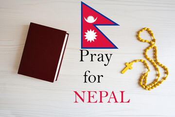 Pray for Nepal. Rosary and Holy Bible background.