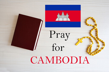 Pray for Cambodia. Rosary and Holy Bible background.
