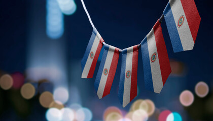 A garland of Paraguay national flags on an abstract blurred background