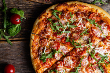 Appetizing pizza with ham on a wooden background