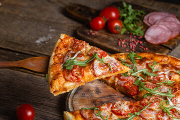 Appetizing pizza with ham on a wooden background