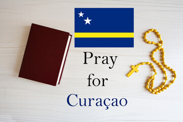 Pray for Curacao. Rosary and Holy Bible background.