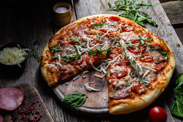 Appetizing pizza with ham on a wooden background