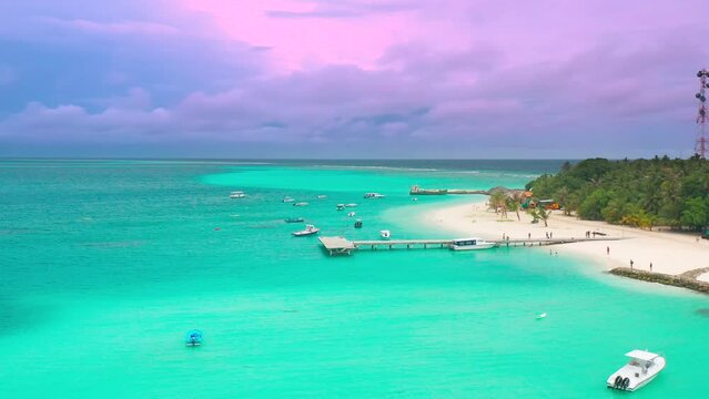 Aerial sunset view on turquoise sea with port in Fulidhoo island on Maldives. Landscape seascape and concept travel vacation