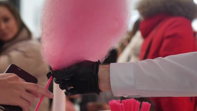 Hands making cotton candy candyfloss with special machine. gimbal stabilizer motion movement closeup shot.