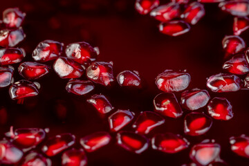 Grains of red ripe pomegranate close up