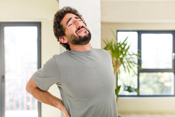 young adult crazy man with expressive pose at a modern house interior