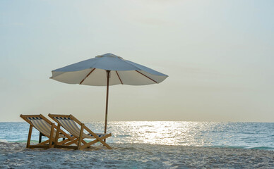 Summer vacation at a hotel on the beach . Beautiful blue sea and beach accessories. Sun umbrella...
