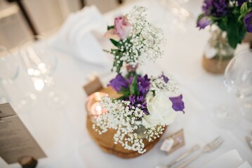 Selective focus of a dried Gypsophila bouquet with colorful flowers on a festive table