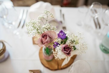 Selective focus of a dried Gypsophila bouquet with colorful flowers on a festive table
