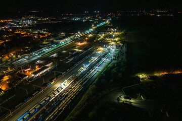 night aerial view over long railway freight trains with lots of wagons stand on parking