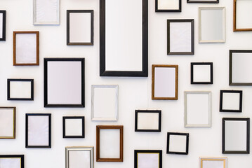 Many empty picture frames on the white wall, home decoration