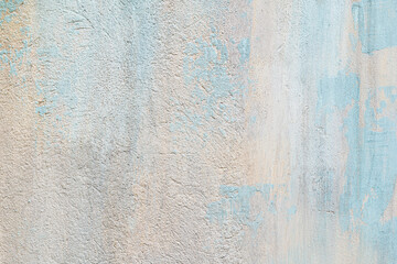 Rough concrete wall painted in pastel tone and faded