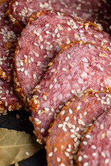 Sliced sausage with spices and lots of sesame seeds