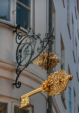 Copenhagen, Denmark - September 13, 2010: Wrought large Golden keys above corner of Sankt Peders and Larslejsstraete, now a Thai Massage service. White facade.