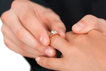 Close up Groom Putting the Wedding Ring on bride