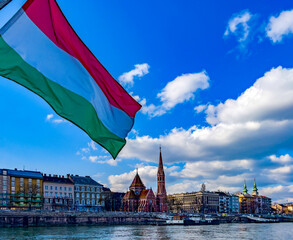 Hungarian flag and View of the Calvinist Church and the Buda side of Budapest from the Danube river