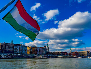 Hungarian flag and View of the Calvinist Church and the Buda side of Budapest from the Danube river