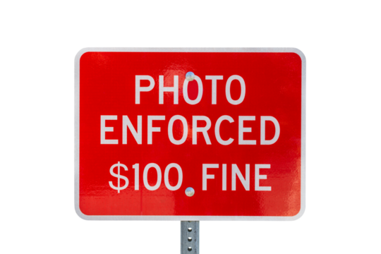 Photo enforced $100 fine warning sign isolated with cut out background.