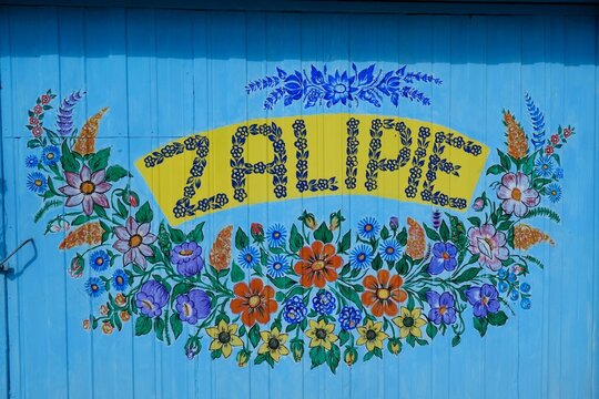 Zalipie, Poland - circle June, 2020: Famous polish village Zalipie with traditional hand painted floral decorations on old wooden houses and various items