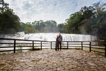 Tourists couple in Agua Azul park in Palenque Mexico - 589585001