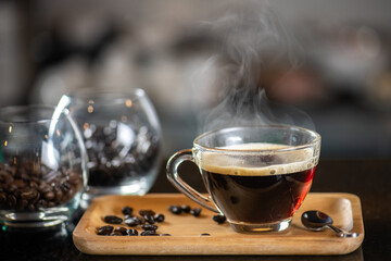 black drip coffee in glass cup, Barista making drip coffee by pouring spills hot water on coffee bean. Barista serve holding cup of hot black coffee or americano for serve on wooden table cafe shop
