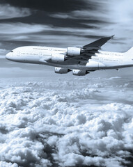 Passenger commercial airplane flying in the sky above clouds. Concept of fast modern travel