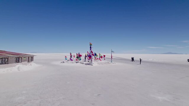 Uyuni flags from many nations waving with the wind shot by drone