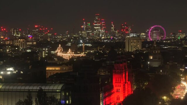 Night timelapse of the London skyline featuring illuminated historic and modern architecture, city lights, and the London Eye glowing across central London, United Kingdom.
