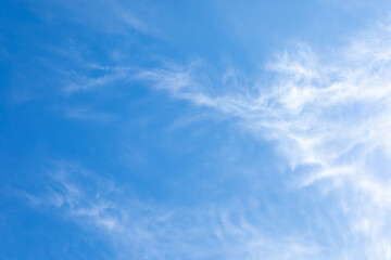 Natural white cirrus clouds on blue sky. Beauty of bright blue and white skyscape.