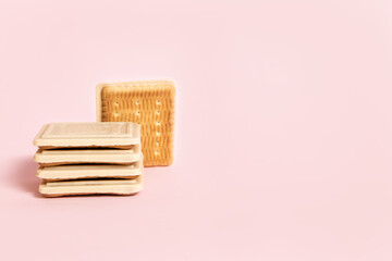 White chocolate-covered cookies on pink background	