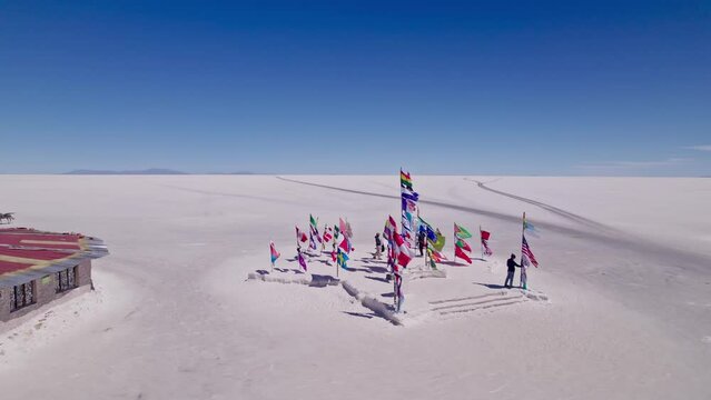 Uyuni flags from many nations waving with the wind. Drone shot