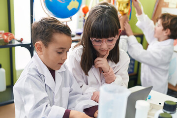 Group of kids scientists students using laptop at laboratory classroom