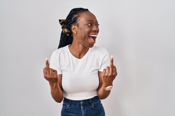 Beautiful black woman standing over isolated background showing middle finger doing fuck you bad...