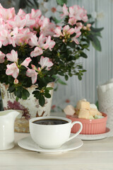 cup of coffee with marshmallow on white wooden table