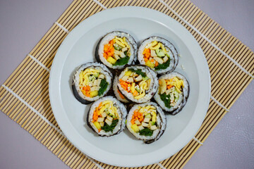 Gimbab, korean sushi roll served on a plate. seaweed rice roll made of gim. Korean street food.