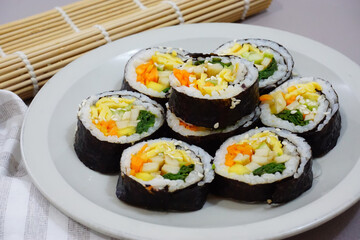 Gimbab, korean sushi roll served on a plate. seaweed rice roll made of gim. Korean street food.