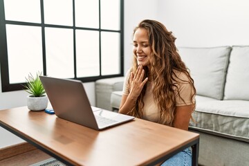 Young beautiful hispanic woman having video call communicate with sign deaf language at home
