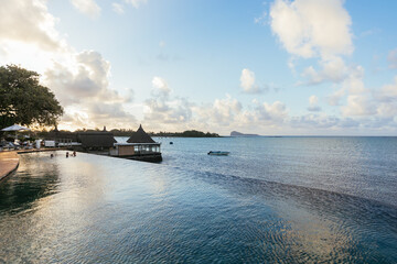 Island Villa swimming pool. Infinity hotel pool in Mauritius.  Summer vacation at poolside. Veranda...