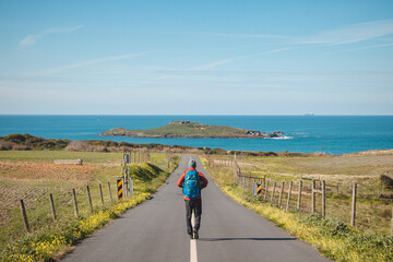 Man full of enthusiasm embarks on his journey along the Fisherman trail - Rota Vicentina along the Atlantic coast of Portugal. Adventurous backpacker hits the road in the spring months