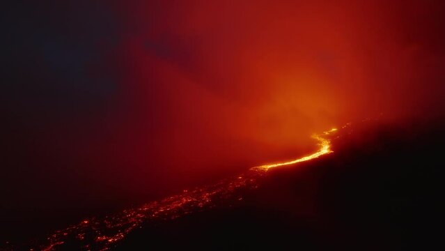 4K drone aerial video of Hawaiian Volcanic eruption 2022. Kilauea volcano on Mauna Loa Big Island in Pacific Ocean one of the most active volcano in world. Hot lava and magma of crater at dark night