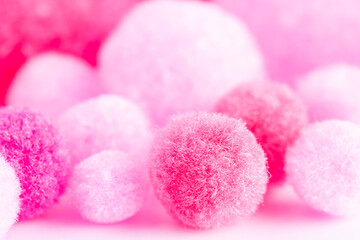 Obraz na płótnie Canvas Colorful mini pom poms, pink and white. .Heap of small fluffy ball, macro shot