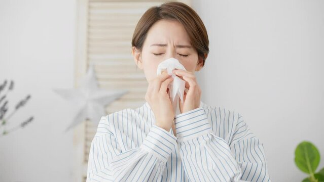 鼻炎で苦しむ若い女性　花粉症イメージ	