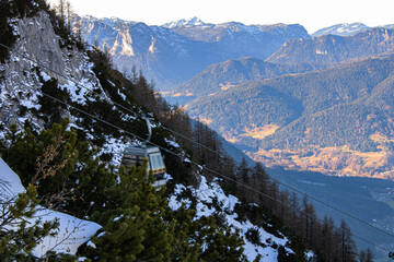 Winter landscape in the Apls with snow covered mountains, winter forest and funicular railway