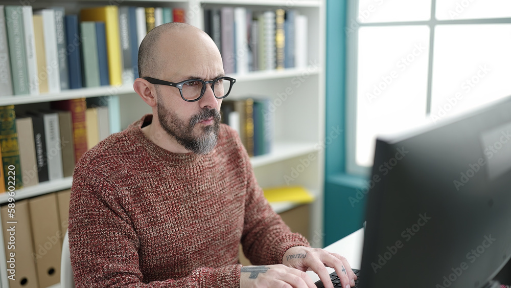 Canvas Prints Young bald man student using computer studying at university classroom