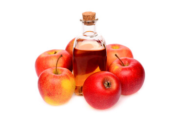 Natural apple cider vinegar. On an isolated white background. In a small bottle and surrounded by apples.