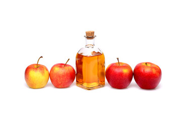 Natural apple cider vinegar. On an isolated white background. In a small bottle and surrounded by apples.