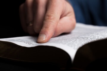 Naklejka premium Christian concept. Young person reading Holly Bible book