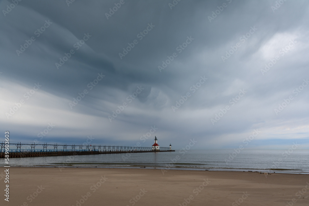 Wall mural Storm clouds approaching St. Joseph lighthouse and beach.  St. Joseph, Michigan, USA.