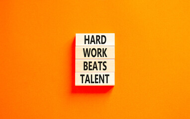 Hard work beats talent symbol. Concept words Hard work beats talent on wooden block. Beautiful orange table orange background. Motivational business hard work beats talent concept. Copy space.